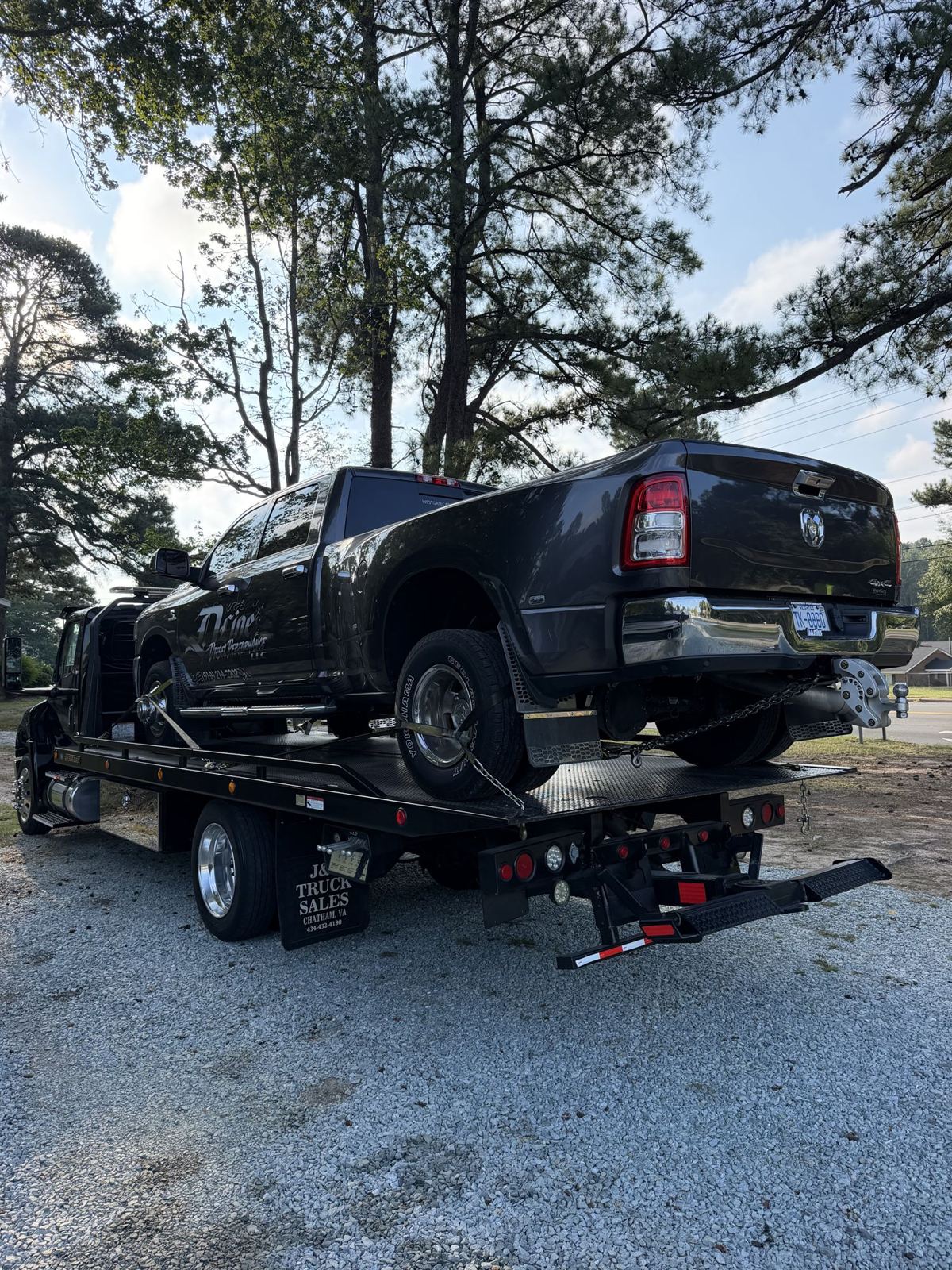 Ram dually pickup chained down on Ortma Towing's 22-ft Jerr-Dan steel rollback